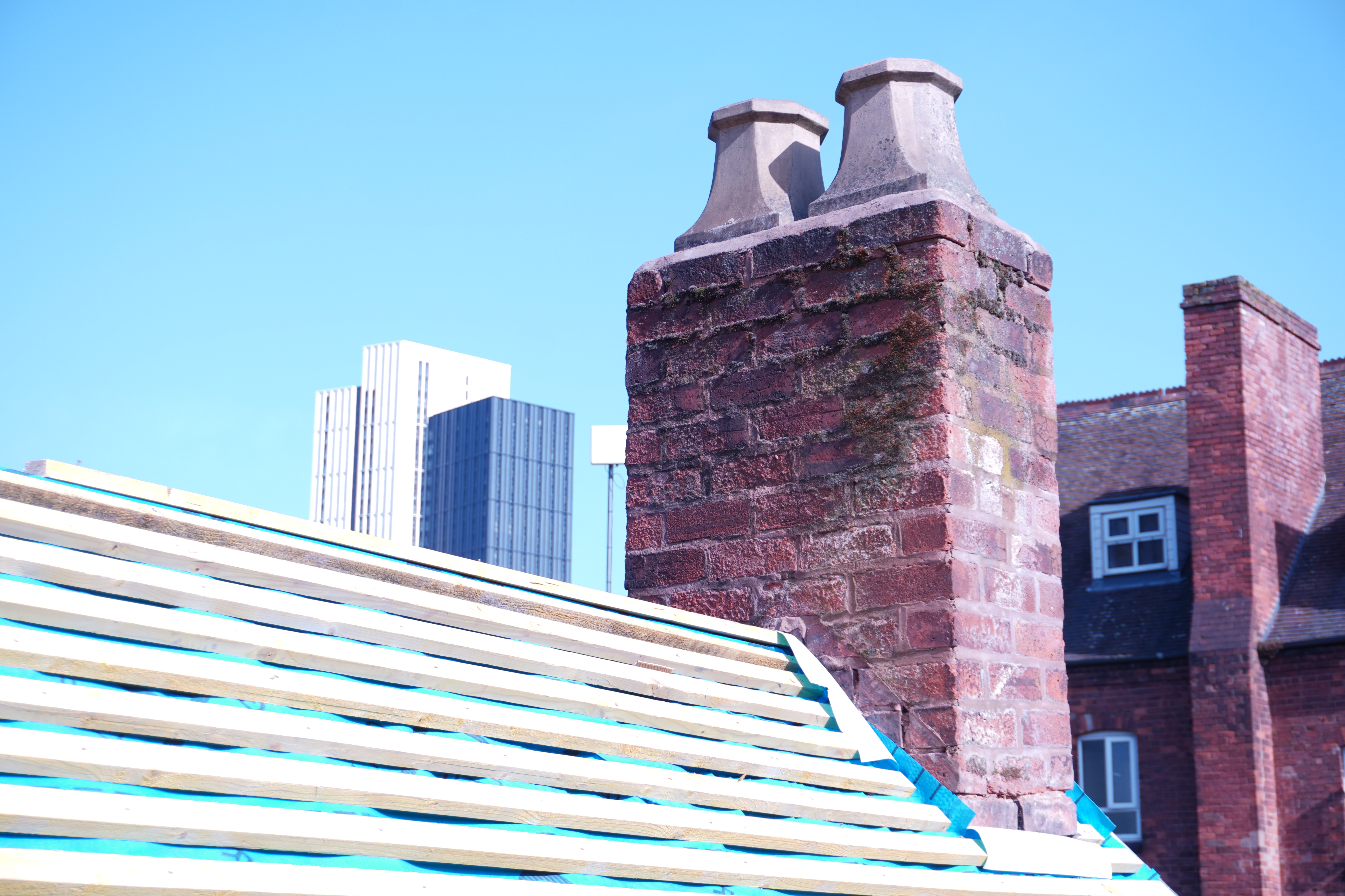 Brick chimney stack with chimney pots — chimney work in progress
